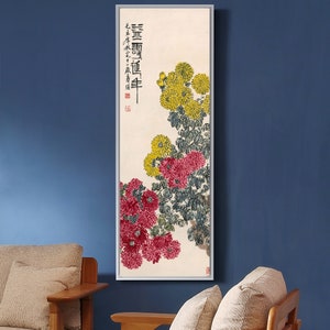 May include: A vertical painting of a floral arrangement with yellow and red chrysanthemums. The painting is on a cream background with black calligraphy text in the upper left corner. The text reads "深雪飄香迎春年".