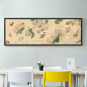 May include: A framed print of a traditional Chinese painting depicting a bird perched on a branch with pink flowers and butterflies. The painting is set against a light beige background.