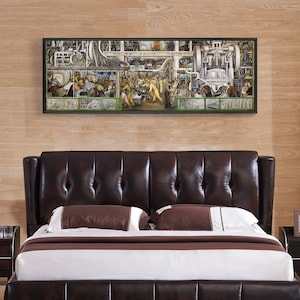 May include: A black and white framed print of a mural depicting a factory scene with workers operating machinery. The mural is titled "The American Way" and is set against a wood-paneled wall.