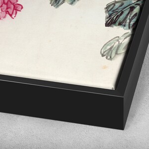 May include: A framed canvas print featuring a watercolour painting of pink flowers and green leaves. The frame is black and the canvas is white.