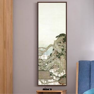 May include: A framed print of a Japanese-style landscape painting. The painting depicts a forest with a white sky and a light blue river in the background. The trees are a dark green and brown color.