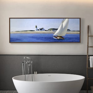 May include: A framed painting of a sailboat sailing past a lighthouse on a sunny day. The water is blue and the sky is light blue. The lighthouse is white with a black roof. The sailboat has a white sail and a brown hull.