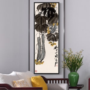 May include: A black and white ink painting of a gourd vine with long, thin gourds hanging from the vine. The painting is framed in a black frame and has a white background. The painting is titled "生不虚此生" in Chinese characters.