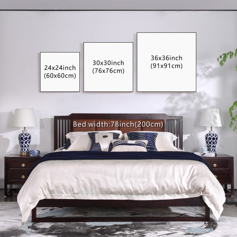 May include: Three white framed canvas prints with black text showing different sizes in inches and centimeters. The prints are hanging on a white wall above a brown wooden bed with a white linen headboard and white bedding. The bed is 78 inches (200 cm) wide.