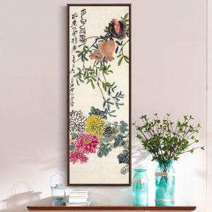 May include: A framed painting depicting a branch with green leaves, pink and yellow flowers, and a pomegranate. The painting is in a traditional Chinese style and features calligraphy in black ink.
