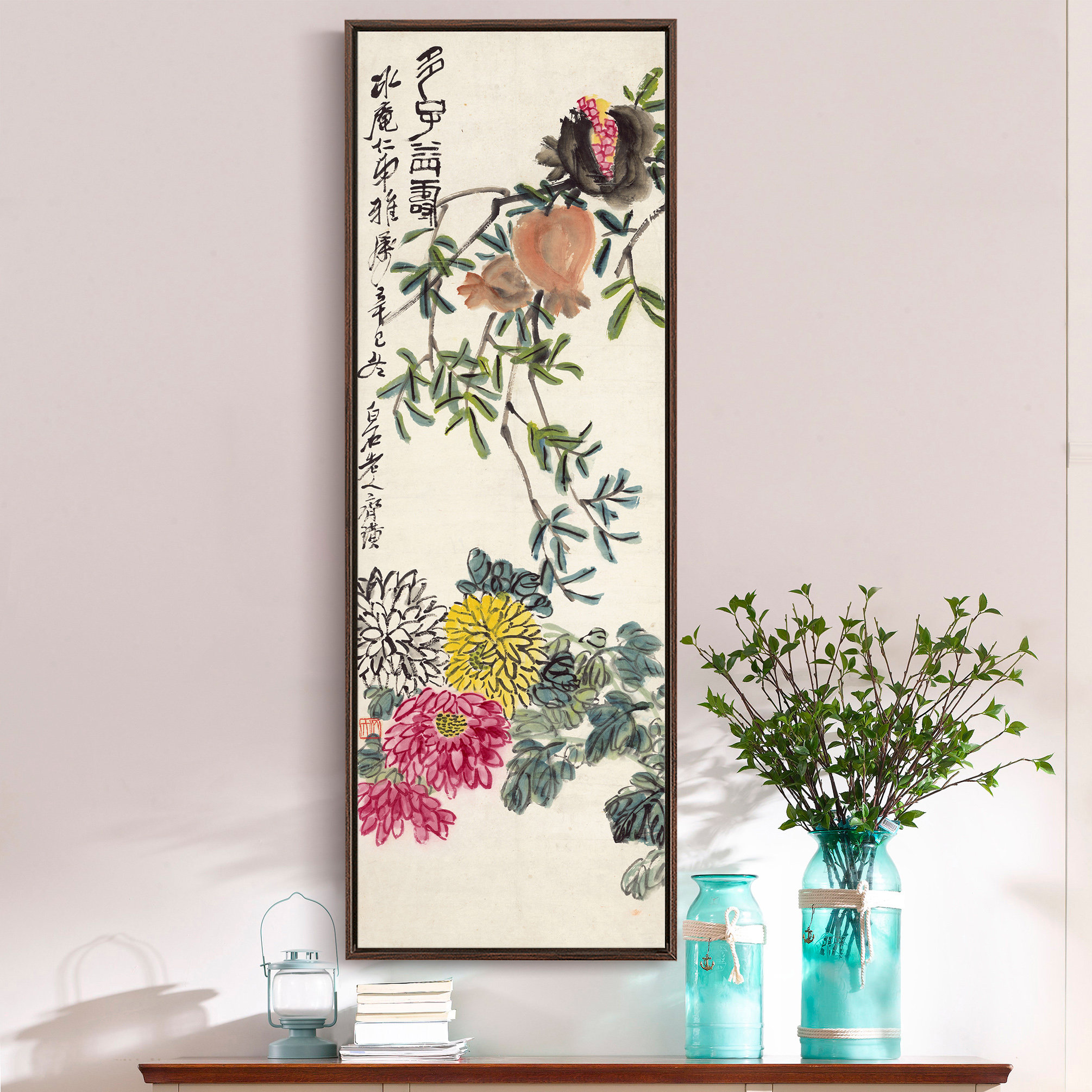 May include: A framed painting depicting a branch with green leaves, pink and yellow flowers, and a pomegranate. The painting is in a traditional Chinese style and features calligraphy in black ink.