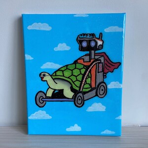 May include: A hand-painted canvas depicting a robot riding a turtle in the sky. The robot is orange and grey with a red cape. The turtle is green and has a brown shell. The background is blue with white clouds.