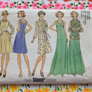 May include: A Simplicity 6999 sewing pattern envelope featuring illustrations of five different dress and blouse styles. The text includes "6999 Simplicity", "Look Slimmer pattern", and "CONTAINS TWO SIZES Bust 45 & 47 Half Size". The background is white.