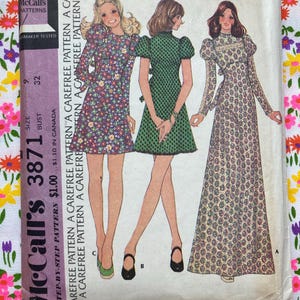 May include: A vintage McCall's 3871 sewing pattern envelope for a misses' and junior dress. The front features illustrations of three dress variations: a short floral dress, a short green polka dot dress, and a long-sleeved paisley maxi dress.