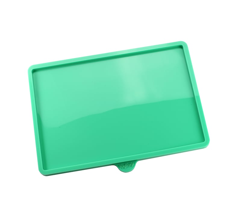 May include: A green silicone tray with the word "remarkable" printed on the bottom.