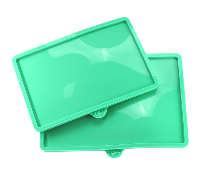 May include: Two green silicone baking mats with the word "Reflaty" printed on each. The mats are stacked on top of each other.