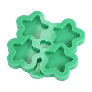 May include: Green silicone mould with four star-shaped cavities and one heart-shaped cavity. The mould is labelled "Reimagine".