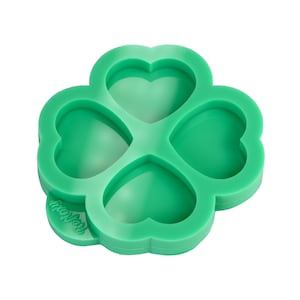May include: Green silicone mould shaped like a four-leaf clover with four heart-shaped cavities. The mould is labelled "HappyJoy".