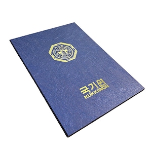 May include: A blue certificate with gold lettering and a textured surface. The certificate features a gold emblem with a globe and the words "WORLD TAEKWONDO" and Korean text. The text "KUKKIWON" is also visible.