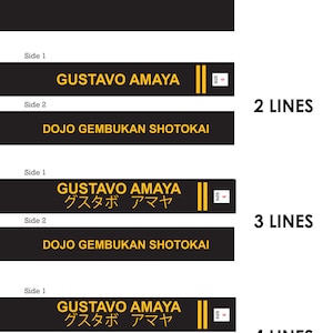 May include: Black martial arts belt with gold text reading "GUSTAVO AMAYA" and "SIZE 6". The second side of the belt is blank. The belt is for martial arts.