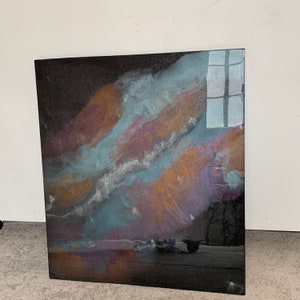 May include: Abstract resin art painting with a black background and swirling colors of blue, purple, and orange. The resin has a glossy finish and sparkles with glitter.