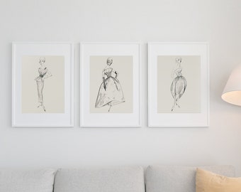 May include: Three framed black and white line drawings of women wearing dresses. The drawings are in a minimalist style and are displayed on a white wall.