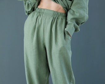 May include: A pair of wide-leg, green linen pants with an elastic waistband. The pants are made of a soft, comfortable fabric and have a relaxed fit.
