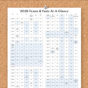 May include: A printed calendar titled "2026 Feasts & Fasts At-A-Glance" pinned to a corkboard. The calendar features a grid layout with dates and days of the week, with various religious holidays highlighted.