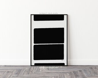 May include: Black and white abstract art print with three horizontal black rectangles on a white background. The print is framed in a black frame. The text "bridget f. clark studio" is at the top of the print. The text "goingwestcoastal.com" is at the bottom of the print.