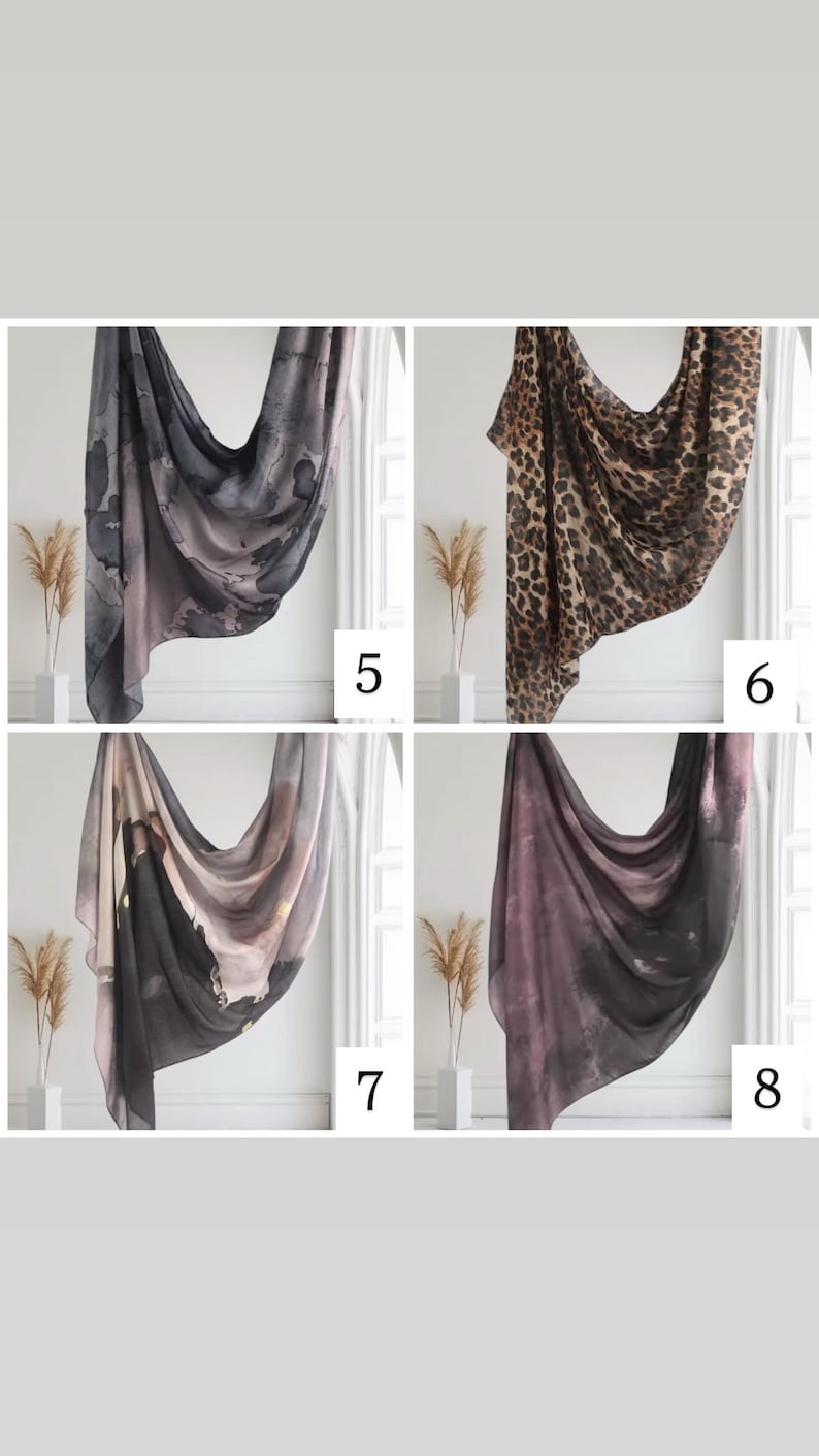 May include: Four different patterned scarves, two with abstract designs in shades of gray and pink, one with a leopard print, and one with a black and white abstract design.