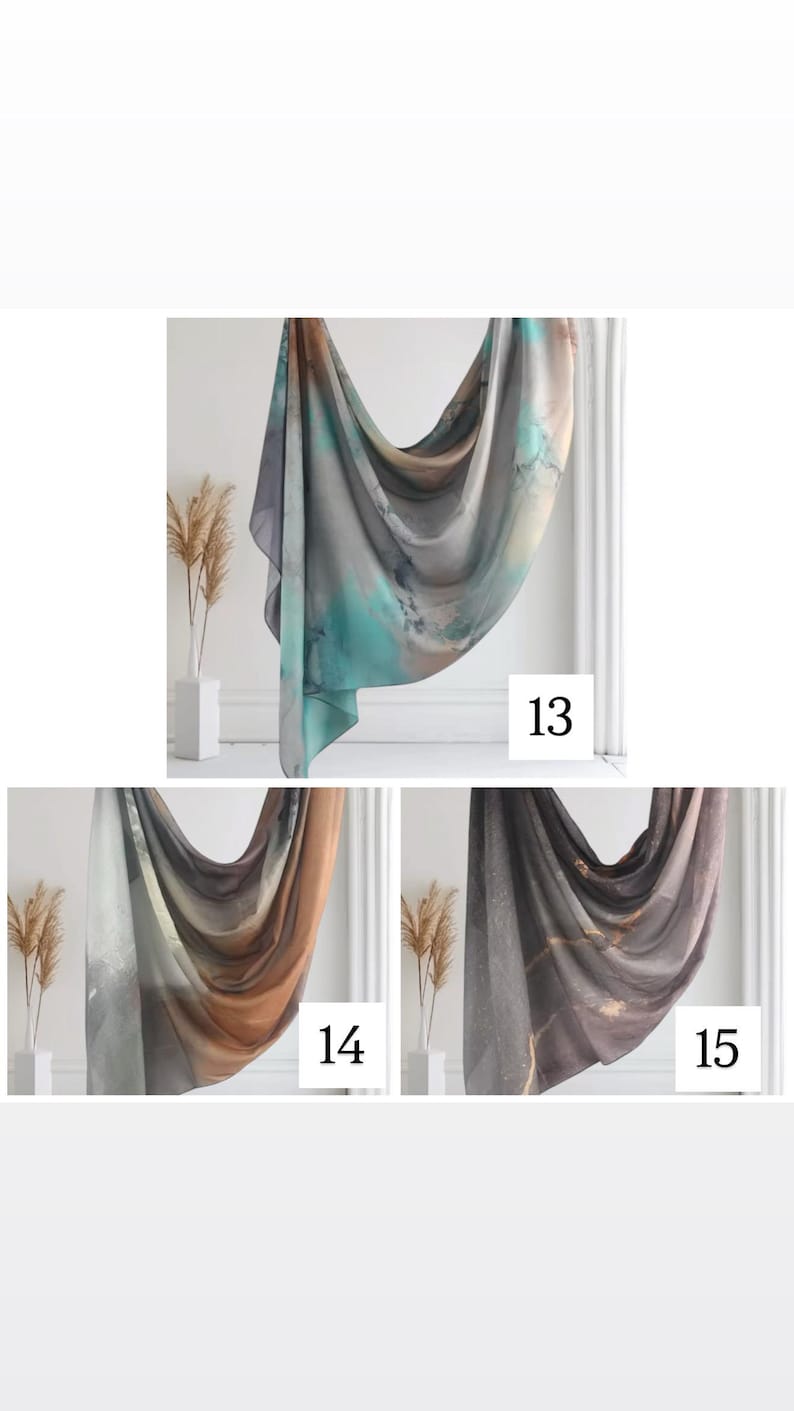 May include: Three different patterned scarves in shades of gray, brown, and teal. The scarves are draped over a white surface with a white vase and dried flowers in the background. The numbers 13, 14, and 15 are visible in the image.