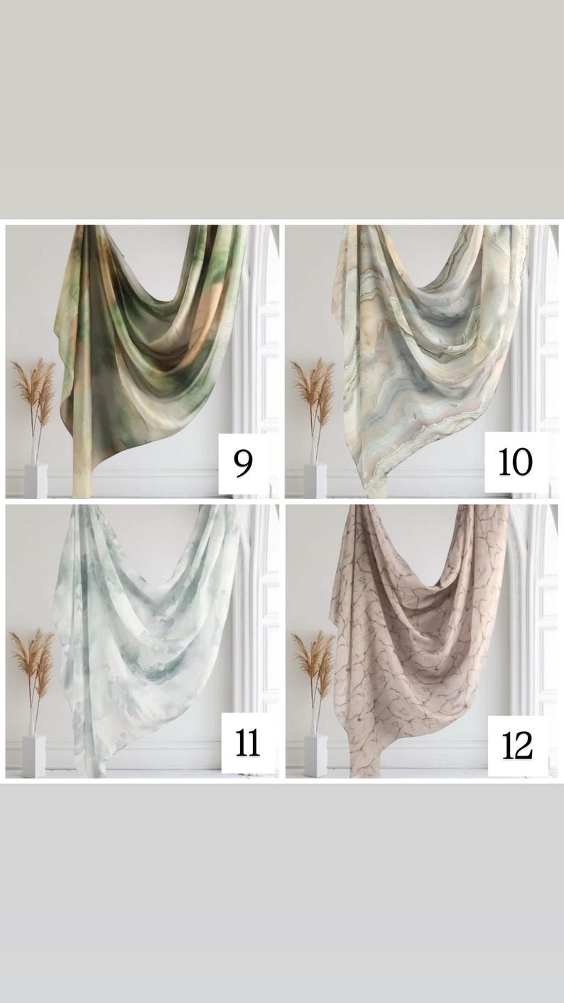 May include: Four different patterned scarves in a variety of colors, including green, brown, white, and pink. The scarves are draped over a white surface with a white trim.