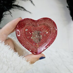 May include: Red heart-shaped resin tray with glitter and the words "Love Yourself" in silver lettering.