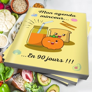 Op de afbeelding: Een gele planner met de tekst "Mon agenda minceur... En 90 jours!!!" De planner bevat illustraties van een glas sinaasappelsap, een snee brood met een vrolijk gezicht en een sinaasappel met een vrolijk gezicht.