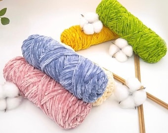 May include: Four skeins of yarn in different colors: pink, blue, yellow, and green. The yarn is soft and fluffy, and it is perfect for knitting or crocheting.