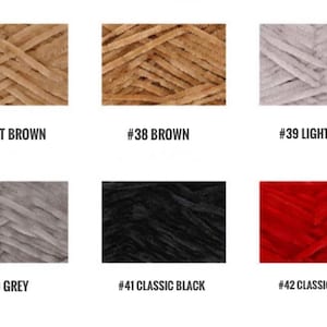 May include: Six skeins of yarn in different colors: light brown, brown, light grey, grey, black, and red. Each skein is labeled with a number and color name.