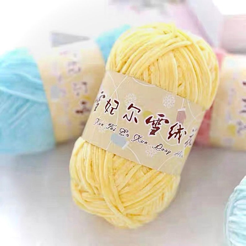 May include: A yellow ball of yarn with a white label that says "Kun Fei En Kuo Dong Hai".