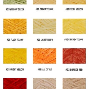 May include: A collection of yarn samples in various shades of yellow, green, orange, and red. The yarn is arranged in a grid pattern with each color labeled with a number and a descriptive name.