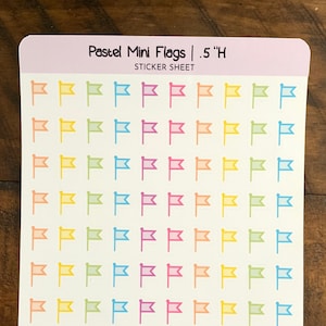 May include: A sticker sheet with pastel colored mini flags. The sheet is labeled "Pastel Mini Flags | .5"H STICKER SHEET" and "Purple Pisces Creations purplepiscescreation.etsy.com".
