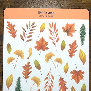 May include: A sticker sheet featuring various fall leaves in shades of orange, yellow, and green. The sticker sheet has the text "Fall Leaves STICKER SHEET" at the top and "Purple Pisces Creations" at the bottom.
