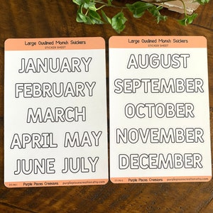 May include: Two sticker sheets with outlined month names. The first sheet has January, February, March, April, May, June, and July. The second sheet has August, September, October, November, and December. Both sheets have the text "Large Outlined Month Stickers" and "Purple Pisces Creations" with their website address.