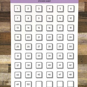 May include: A sticker sheet with 50 white squares, each with a black outline and a number from 1 to 50. The sticker sheet is labeled "Reading Goal Boxes | .6" | 1-50" and "Sticker Sheet".