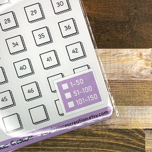 May include: A sheet of white stickers with black outlines and numbers from 1 to 50. The stickers are arranged in a grid pattern. There is a separate sticker with three boxes, each with a number range: 1-50, 51-100, and 101-150. The text "purplepiscescreation.etsy.com" is printed on the bottom of the sticker sheet.