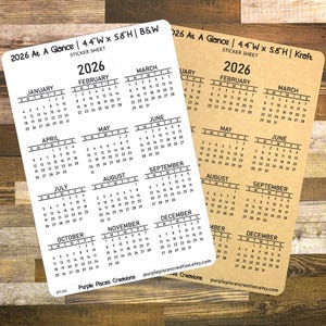 May include: Two sticker sheets with a 2026 calendar. The sheet on the left is white with black text. The sheet on the right is brown with black text. Both sheets are 4.4 inches wide by 5.8 inches high.