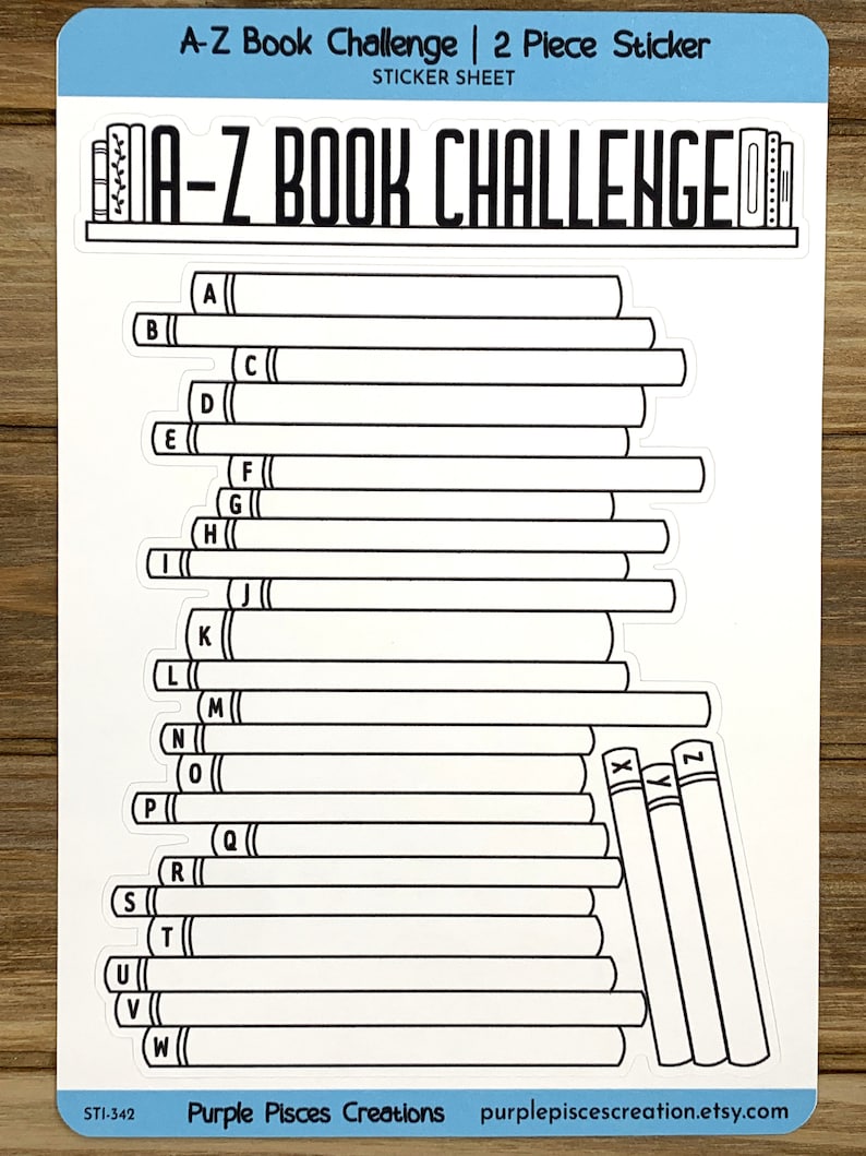 May include: A-Z Book Challenge sticker sheet with 26 blank book spines for a reading challenge. The sticker sheet features a black and white illustration of a bookshelf with books labeled A-Z.