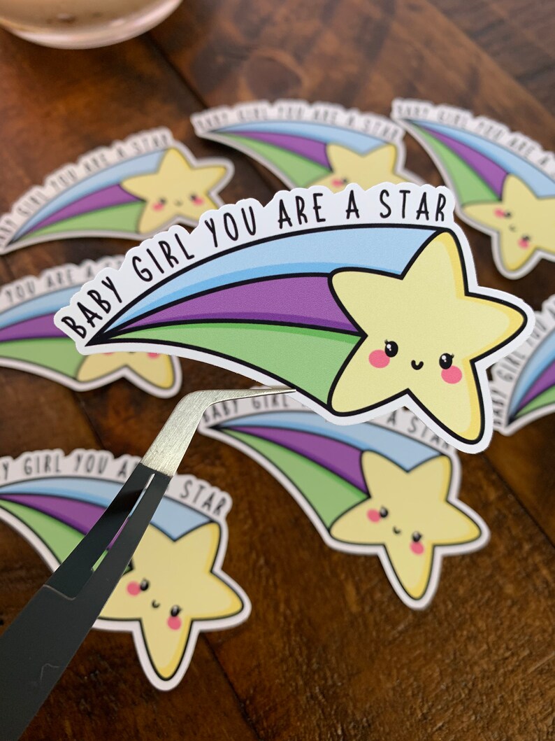 May include: A set of colorful stickers with a shooting star design and the text "Baby Girl You Are A Star".