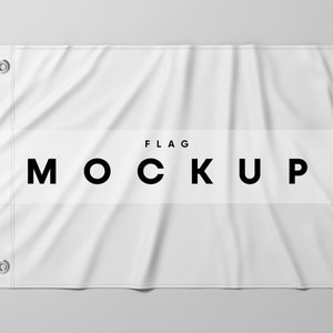 May include: White fabric flag mockup with the word "FLAG" and the word "MOCKUP" in black text.