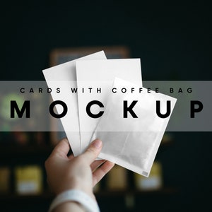 May include: A hand holding three blank white cards and a white coffee bag with the text "CARDS WITH COFFEE BAG MOCKUP" on a transparent overlay.