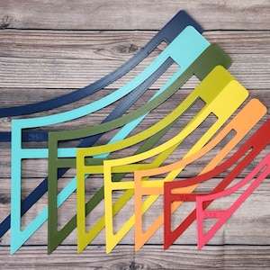 May include: Set of nine colourful plastic rulers in various shades of blue, green, yellow, orange, and red. The rulers are arranged in a fan shape, with the largest ruler at the top and the smallest ruler at the bottom.