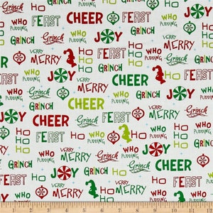 May include: White fabric with a repeating pattern of green, red, and yellow text. The text includes the words "Grinch", "Who", "Feast", "Cheer", "Joy", "Merry", "Ho", and "Pudding".