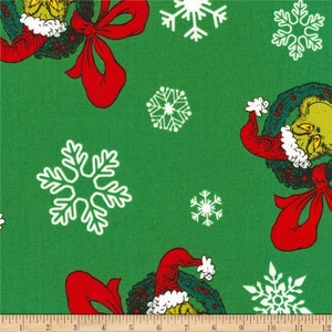 May include: Green fabric with a repeating pattern of the Grinch wearing a Santa hat and holding a wreath, red bows, and white snowflakes.