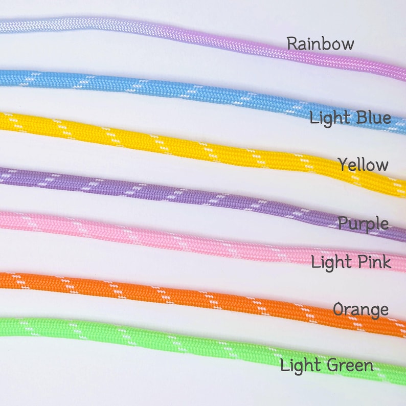 May include: Seven parallel lengths of braided cord arranged horizontally. The colors from top to bottom are labeled as Rainbow, Light Blue, Yellow, Purple, Light Pink, Orange, and Light Green. Each cord features a repeating white diagonal pattern.