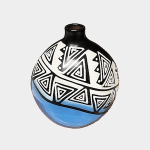 May include: A black ceramic vase with a white and blue geometric pattern. The vase is round and has a narrow neck.
