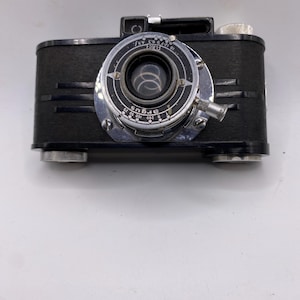 May include: A set of three ceramic nesting bowls. The largest bowl is light blue, the medium bowl is green, and the smallest bowl is yellow. Each bowl has a smooth, glossy finish and a simple, modern design.