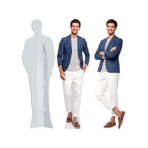 May include: A man wearing a blue plaid blazer, a gray t-shirt, white pants, and brown shoes. The man is standing in front of a white background. A cardboard cutout of a person is on the left.